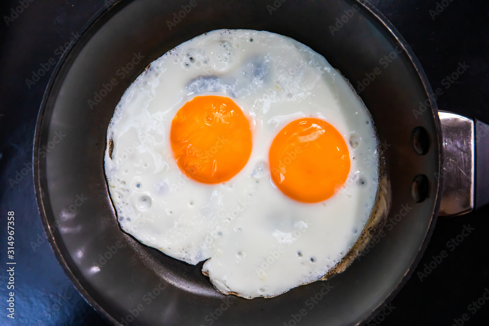 Two fried eggs in cast iron frying pan. Two fried eggs in cast iron frying pan.