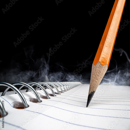 Tilted pencil isolated on white notebook with fog