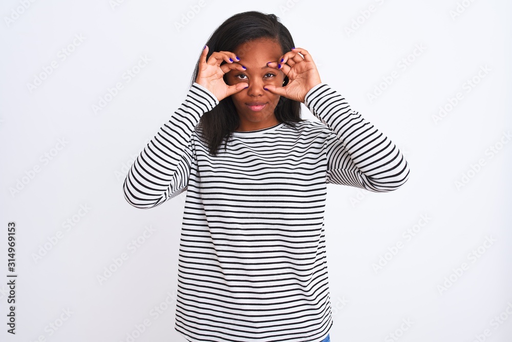 Beautiful young african american woman wearing winter sweater over isolated background Trying to open eyes with fingers, sleepy and tired for morning fatigue Beautiful young african american woman wearing winter sweater over isolated background Trying to open eyes with fingers, sleepy and tired for morning fatigue
