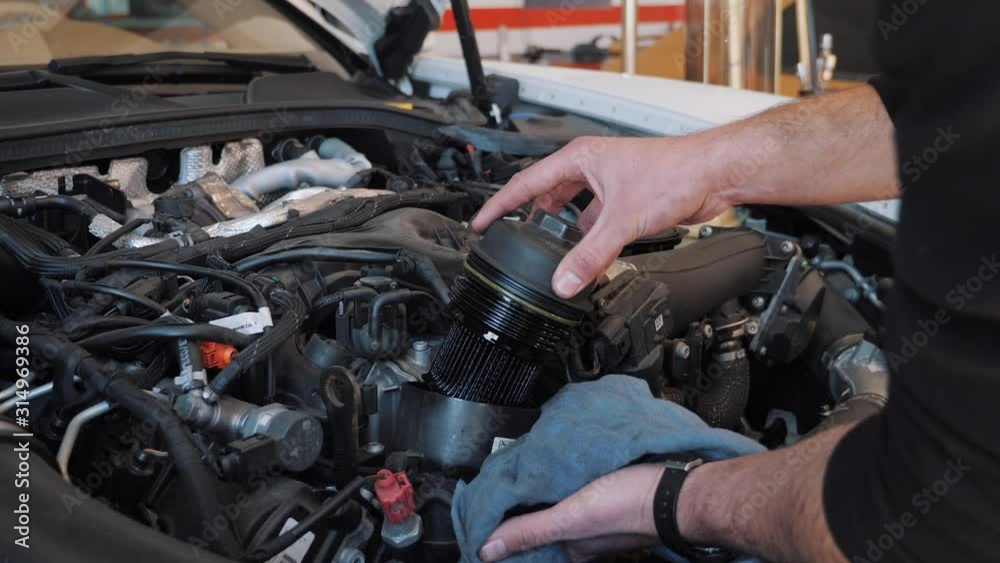 Mechanic doing maintenance on a car Mechanic doing maintenance on a car