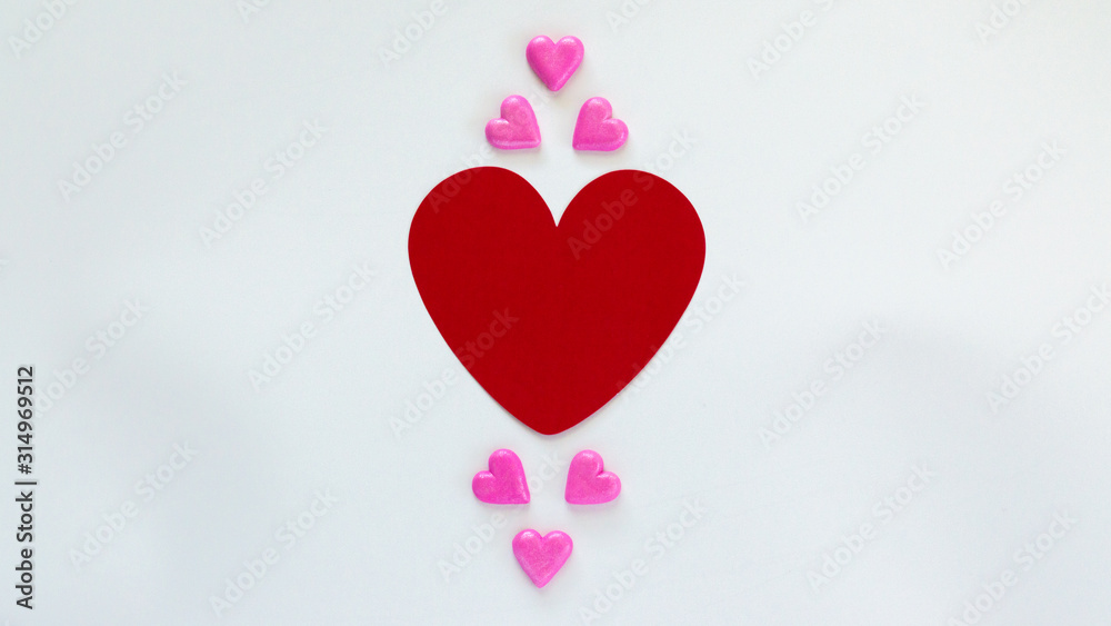a large red heart surrounded by miniature candy hearts isolated on white