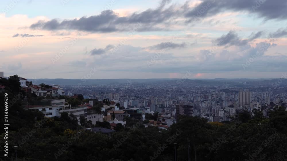 Sunset time lapse of cityscape with high rise buildings and skyscrapers of Belo Horizonte, capital of the state Minas Gerais in Brazil seen from the hills surrounding the urban conglomerate Sunset time lapse of cityscape with high rise buildings and skyscrapers of Belo Horizonte, capital of the state Minas Gerais in Brazil seen from the hills surrounding the urban conglomerate