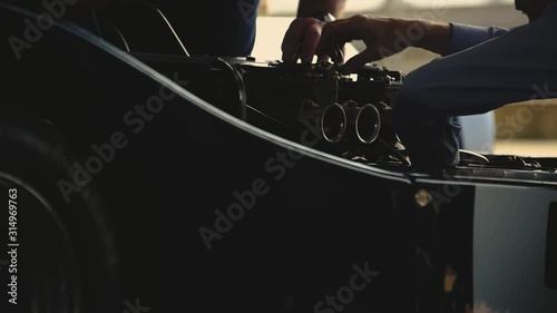 Mechanics working on a sports car. photo