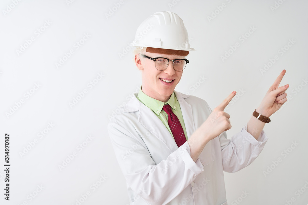 Albino scientist man wearing glasses and helmet standing over isolated white background smiling and looking at the camera pointing with two hands and fingers to the side. Albino scientist man wearing glasses and helmet standing over isolated white background smiling and looking at the camera pointing with two hands and fingers to the side.