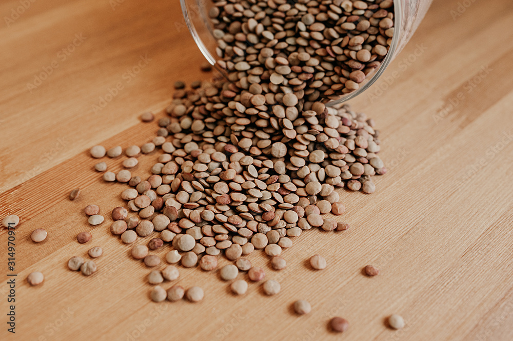 healthy eco-friendly dry group of buckwheat or peas scattered from glass dishes on a light wooden table, cooking vegetarian food healthy eco-friendly dry group of buckwheat or peas scattered from glass dishes on a light wooden table, cooking vegetarian food