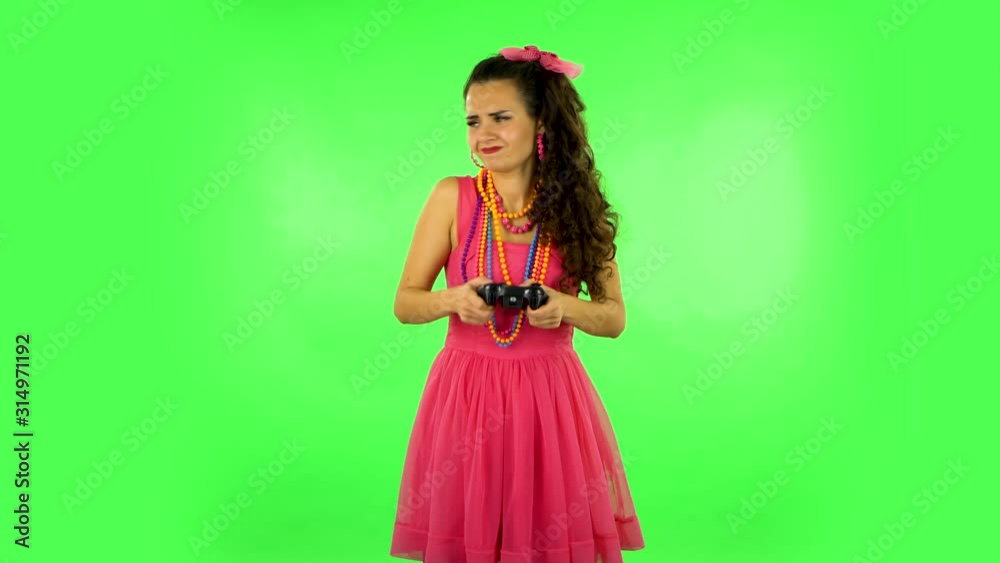 Girl playing a video game using a wireless controller and loses. Green screen Girl playing a video game using a wireless controller and loses. Green screen