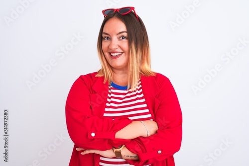 Young beautiful woman wearing striped t-shirt and jacket over isolated white background happy face smiling with crossed arms looking at the camera. Positive person.