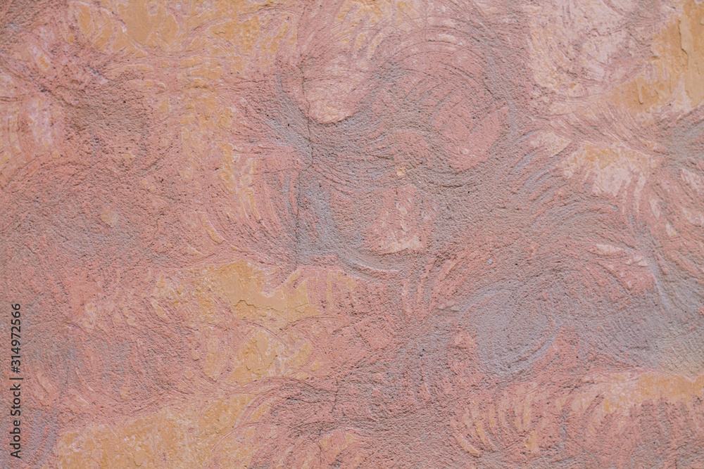The texture of the pink wall. Paint and putty with circles on the wall.