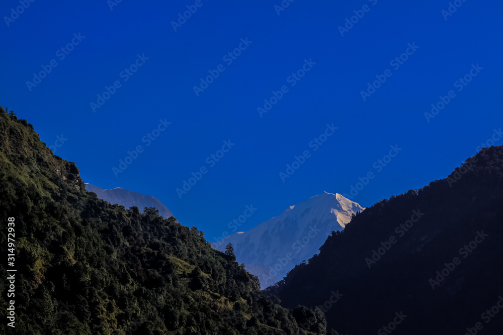 Fototapeta premium Snow-covered Mountain With Blue Sky, Cloud and Fog