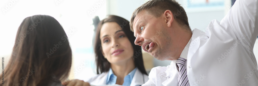 Doctor in medical office reports bad news, if you are not treated, you will die. Psychological help service concept. Black humor meme Doctor in medical office reports bad news, if you are not treated, you will die. Psychological help service concept. Black humor meme