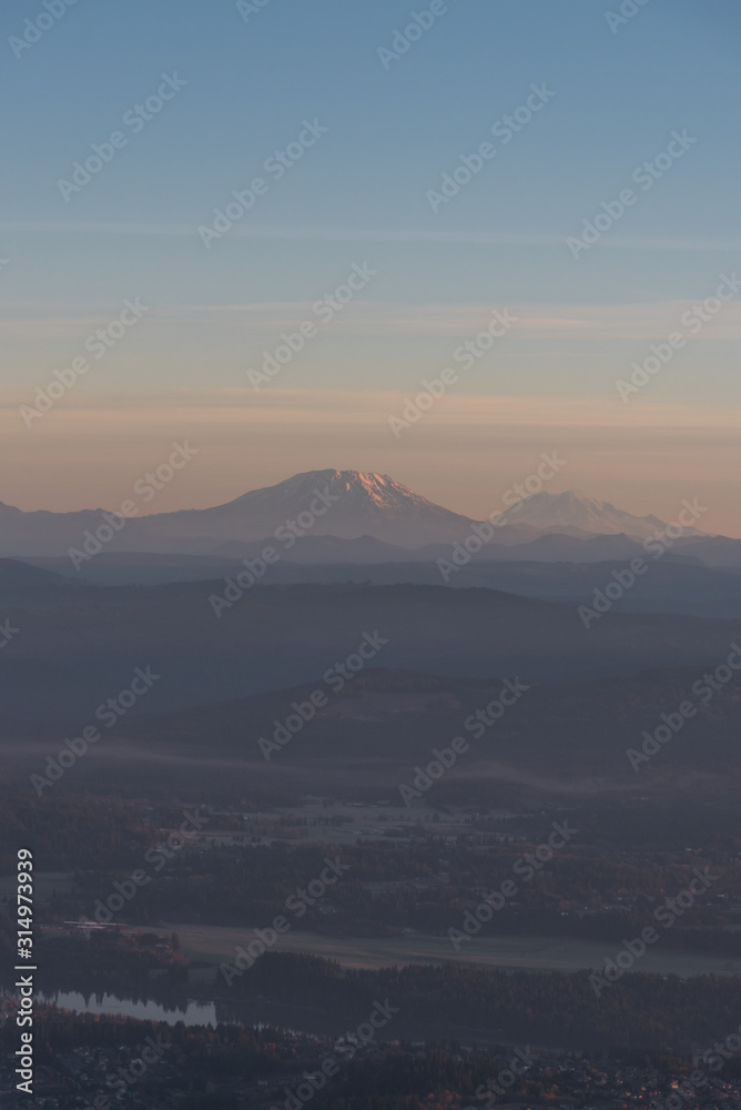 Layers of Pacific Northwest mountains over Portland Oregon from an airplane