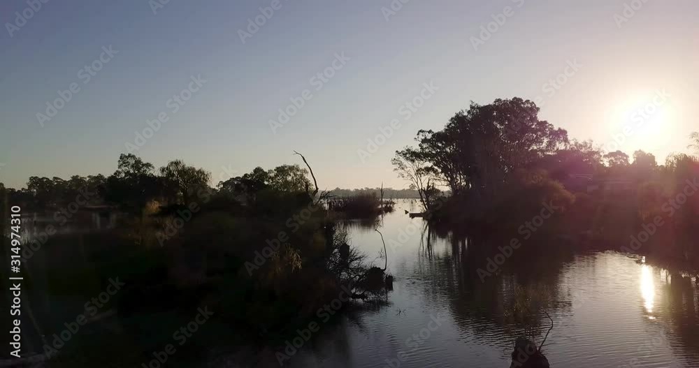 Drone clip over lake with silhouetted trees Drone clip over lake with silhouetted trees
