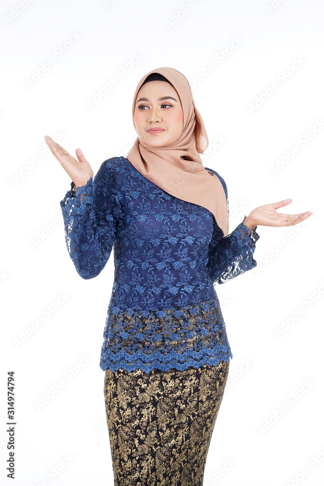 Closeup of a beautiful female Muslim model wearing dark blue modern kurung with hijab, a modern urban lifestyle apparel for Muslim women isolated on white background. Beauty and hijab fashion concept. Closeup of a beautiful female Muslim model wearing dark blue modern kurung with hijab, a modern urban lifestyle apparel for Muslim women isolated on white background. Beauty and hijab fashion concept.