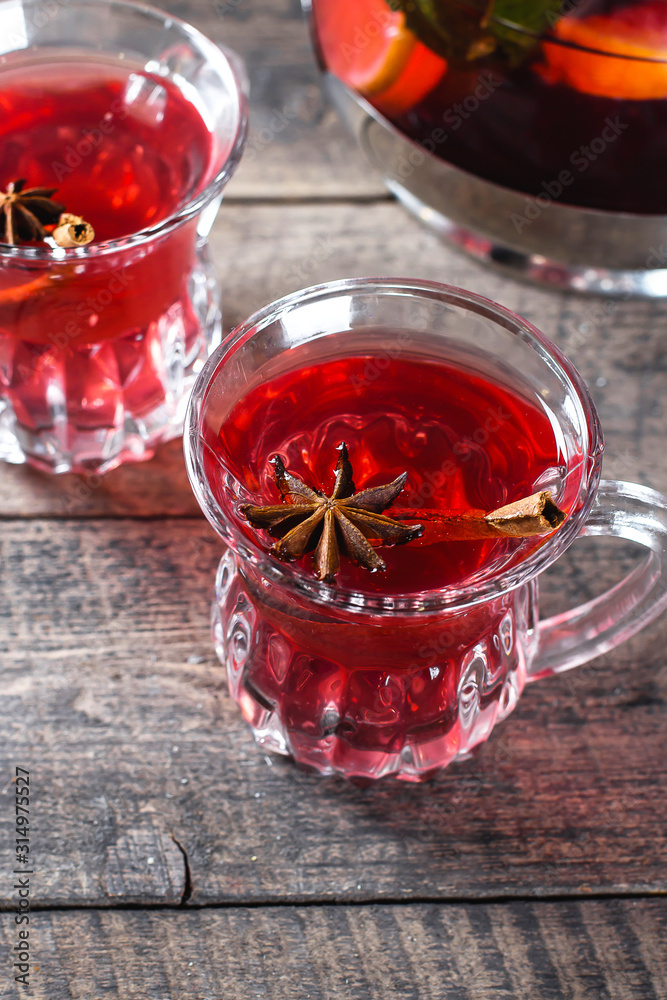 Oriental berry red tea with spices on wooden table background