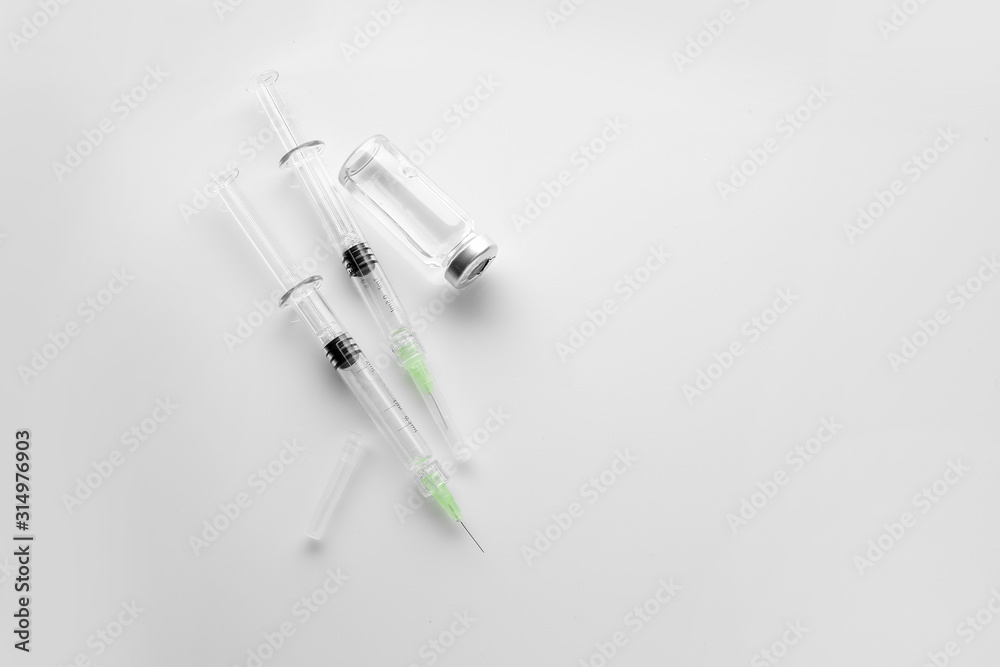Syringes and ampule with filler for cosmetology on white background