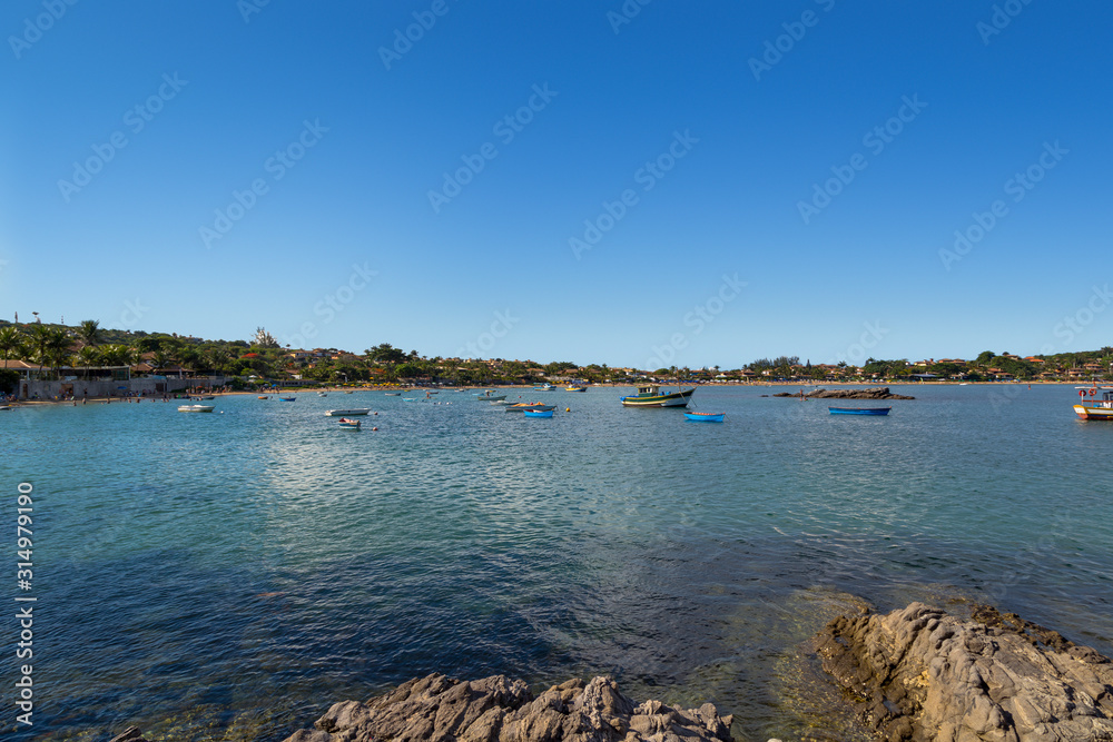 Buzios, Brazil. Beautiful view of Ferradura Beach. Many boats anchored in the bay. Summer and vacations destination in south america. 