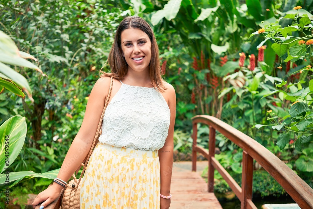 Young beatiful woman smiling happy and cheerful at butterfly garden on a sunny day of summer Young beatiful woman smiling happy and cheerful at butterfly garden on a sunny day of summer