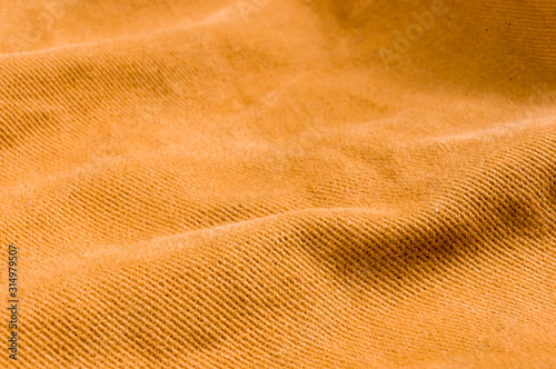 clothing items stonewashed cotton fabric texture with seams, clasps, buttons and rivets, macro