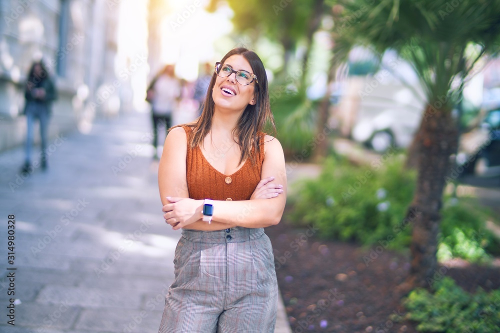 Young beautiful woman smiling happy and confident. Standing with smile on face at the town street Young beautiful woman smiling happy and confident. Standing with smile on face at the town street