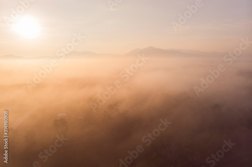 fog covered mountain at sunrise