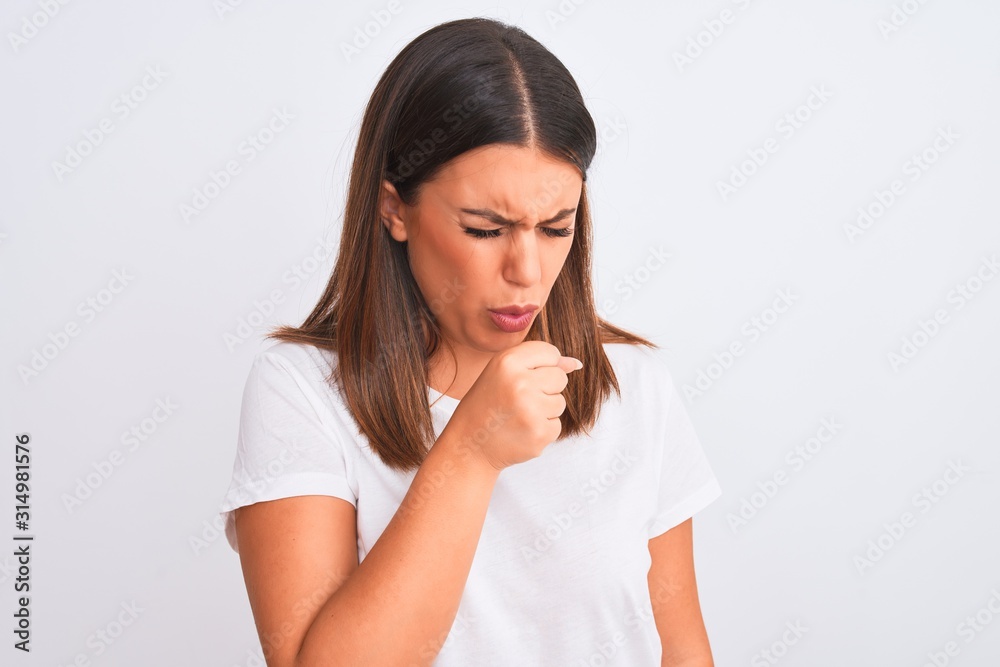 Portrait of beautiful and young brunette woman standing over isolated white background feeling unwell and coughing as symptom for cold or bronchitis. Healthcare concept. Portrait of beautiful and young brunette woman standing over isolated white background feeling unwell and coughing as symptom for cold or bronchitis. Healthcare concept.
