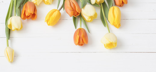 yellow tulips on wooden background