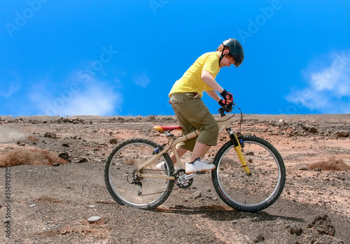 boy riding his mountainbike offroads