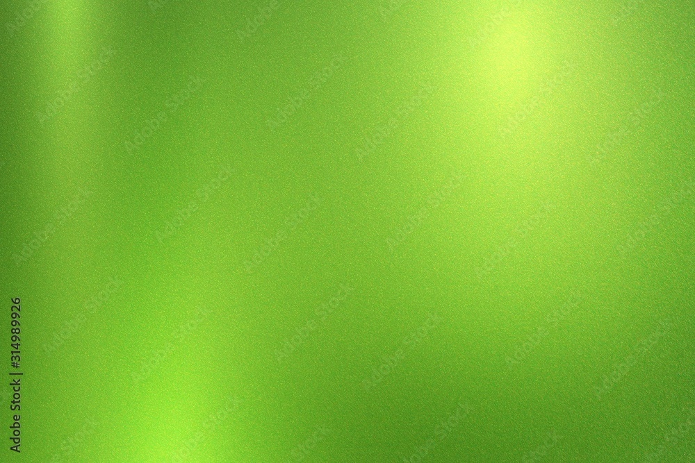 Green foil metallic wall with glowing shiny light, abstract texture background