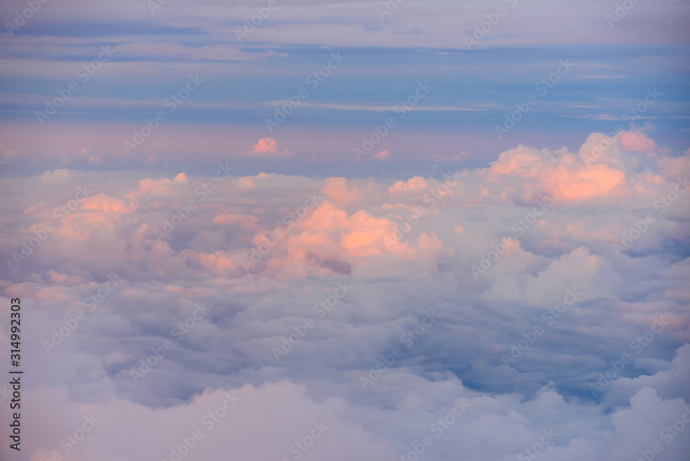 Beautiful view of sunset or sunrise clouds and sky from airplane window