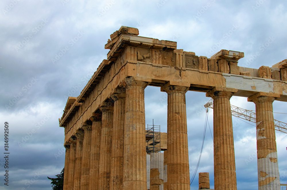 Close-up view of ruins of famous ancient Greek temple of Parthenon against cloudy sky. Famous touristic place and travel destination in Europe. Acropolis, Athens, Greece