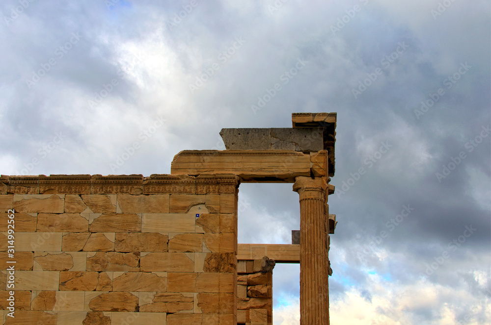 Close up view of ruins of famous ancient Greek temple of The Erechtheion or Erechtheum against rainy clouds. It was dedicated to Athena and Poseidon. Acropolis, Athens, Greece
