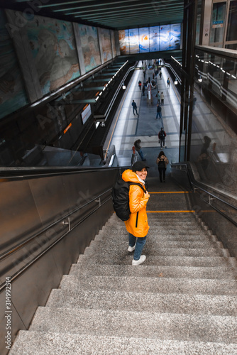 Photography woman walking by stairs down to metro subway underground station