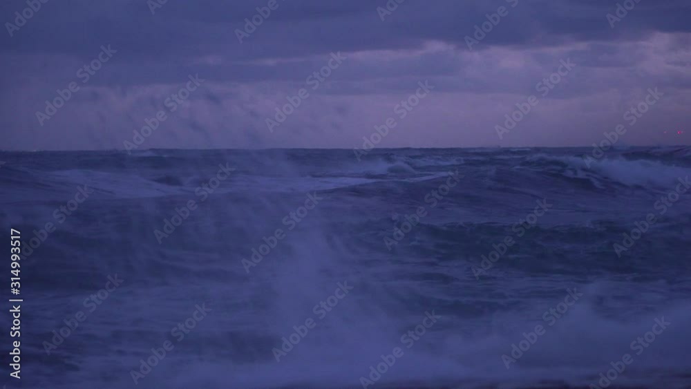 Storm waves crashing rocks coast. Dramatic skies in the evening Storm waves crashing rocks coast. Dramatic skies in the evening