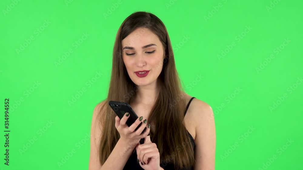 Girl asks for information on the network via phone on green screen