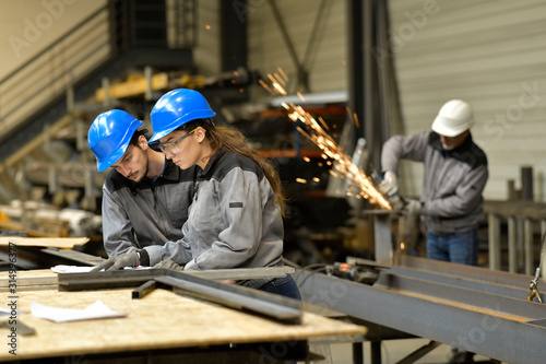Fotografie Apprentice working in steelwork factory