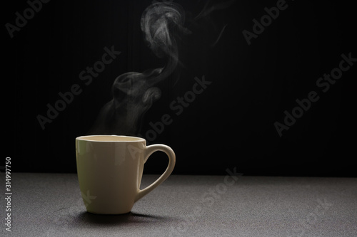 Water hot on wooden table,drink steam and copy space ,selective focus. Beverage warm concept