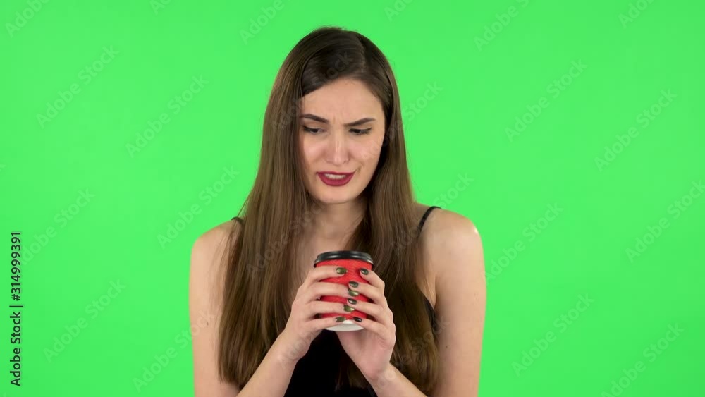 Girl drinks unpalatable coffee and is disgusted on green screen Girl drinks unpalatable coffee and is disgusted on green screen