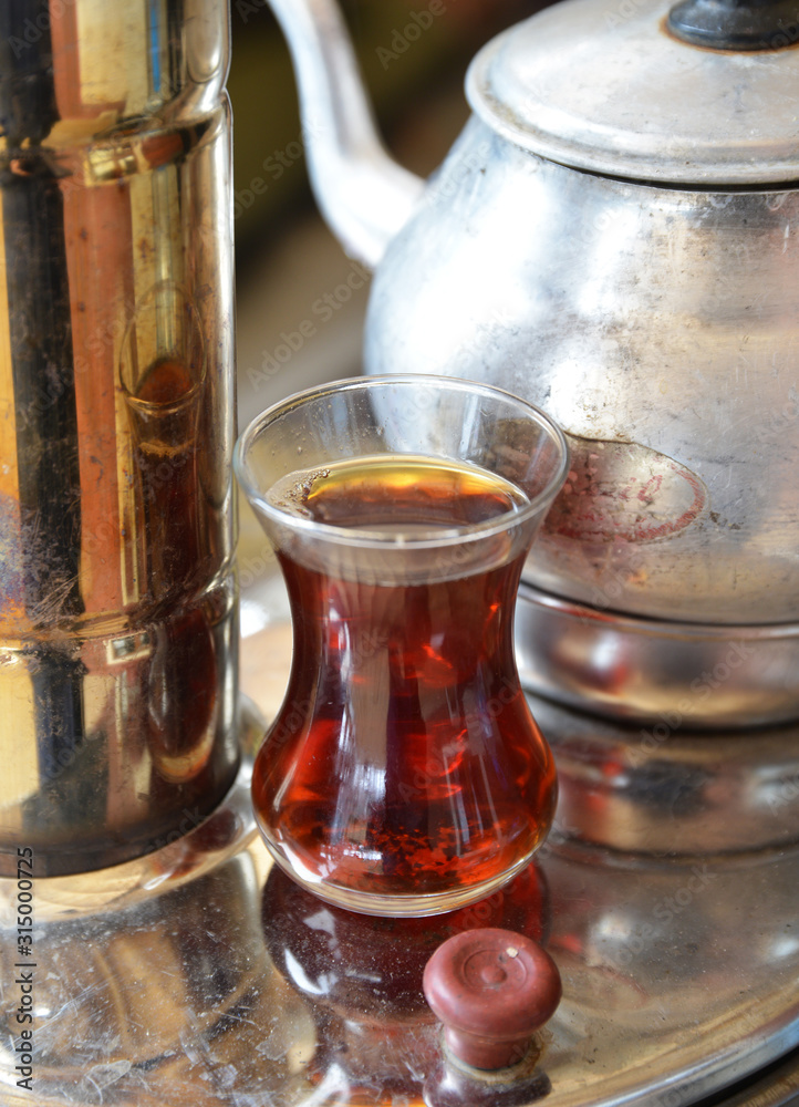 glass of hot Turkish tea and teapot glass of hot Turkish tea and teapot