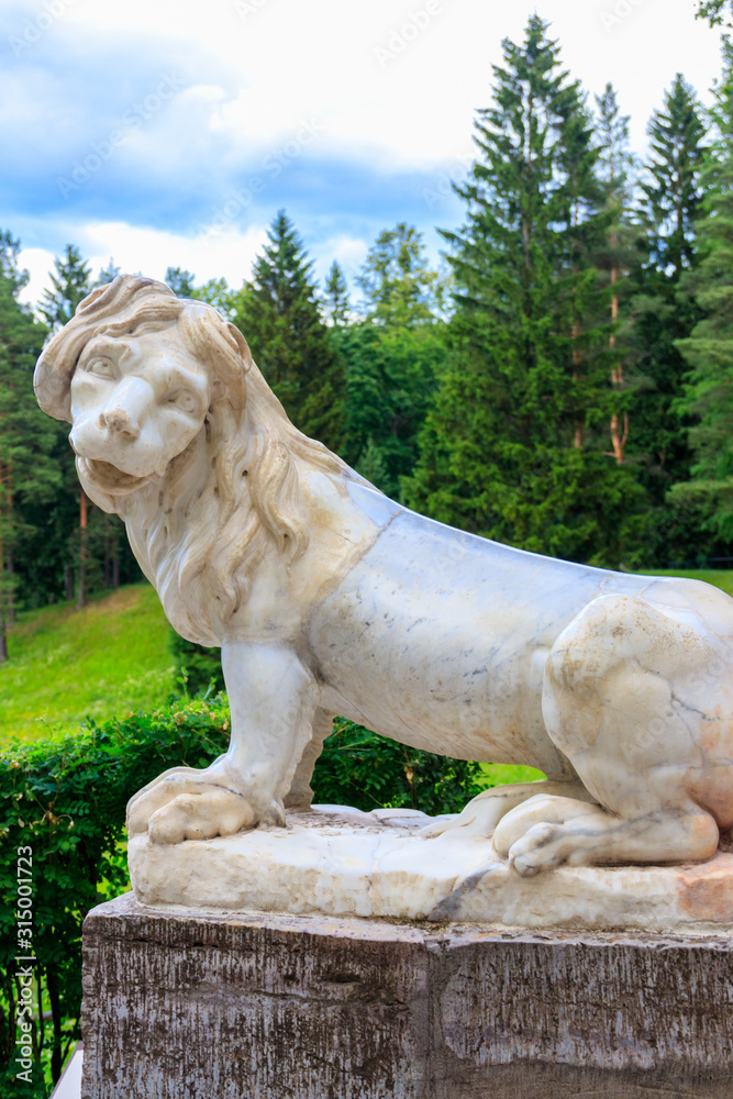 Marble statue of the lion on large stone staircase in Pavlovsk Palace Park