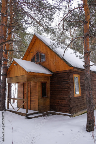 Wooden rustic cottage in the winter woods.