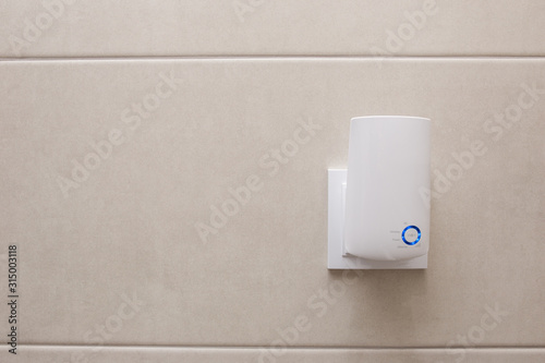 Tableau sur toile Wifi home repeater plugged in closeup.