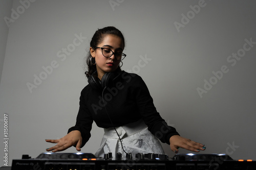 Beautiful DJ girl on decks on the party