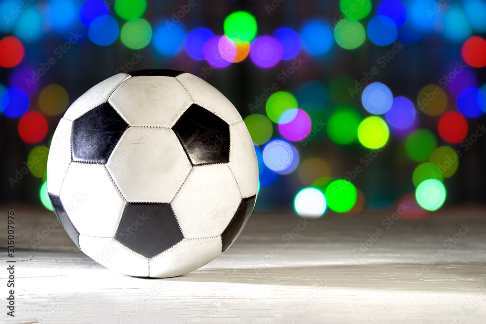 Naklejka premium Soccer ball on bokeh lights background