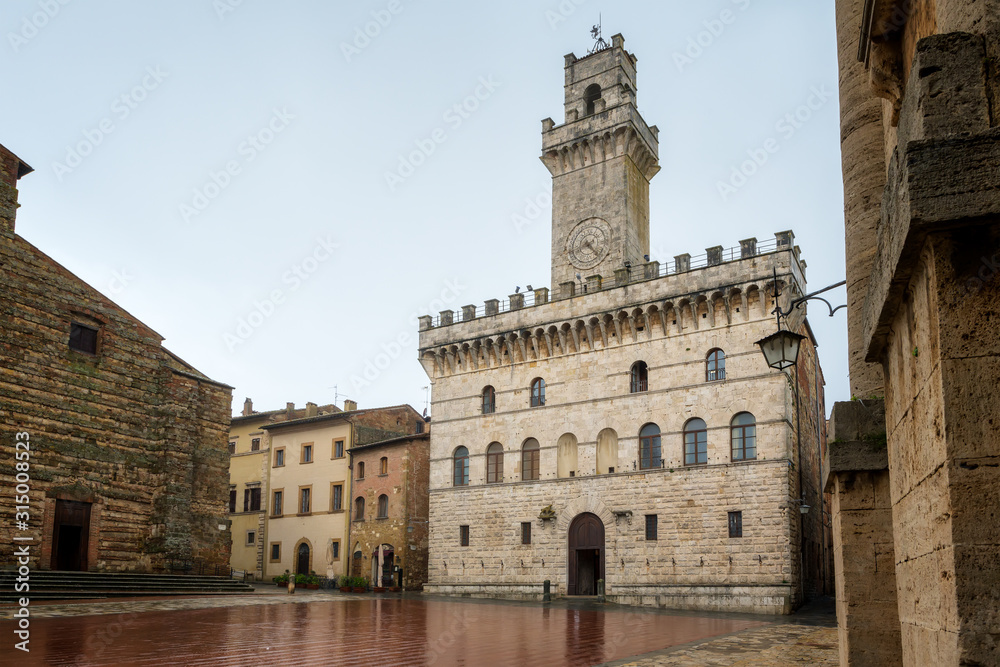 Rainy view of empty medieval Piazza Grande - main square in Montepulciano, Italy with Palazzo Comunale (Town Hall)