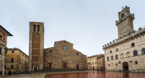 Rainy view of empty medieval Piazza Grande - main square in Montepulciano, Italy with Cathedral of Santa Maria Assunta and Palazzo Comunale (Town Hall).