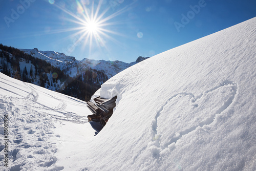bright sunny winter landscape tirol, snow covered alp hut and love heart © SusaZoom
