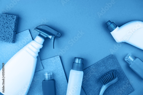 House cleaning products are on blue background. Cleaning concept.