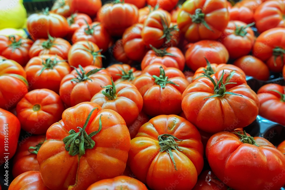 closeup of tomatoes on display at the market closeup of tomatoes on display at the market