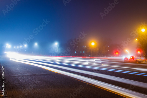 Road at night with light lines from headlights