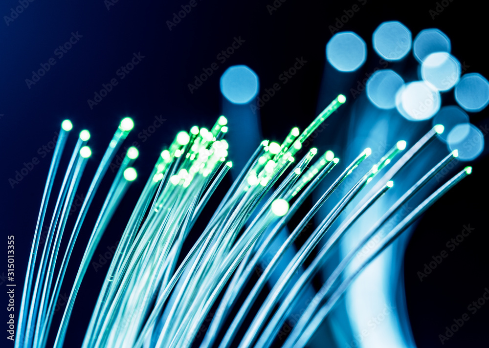 Bundle of optical fibers with lights in the ends. Blue background. Bundle of optical fibers with lights in the ends. Blue background.